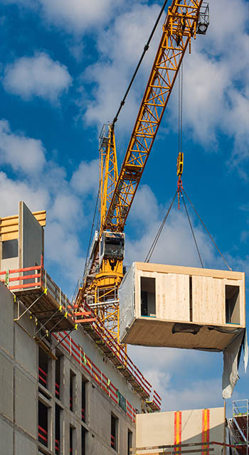 Construction site of an office building in Berlin. The new structure will be built in modular timber construction. MODULAR WOODEN HOUSES made out of renewable resources.