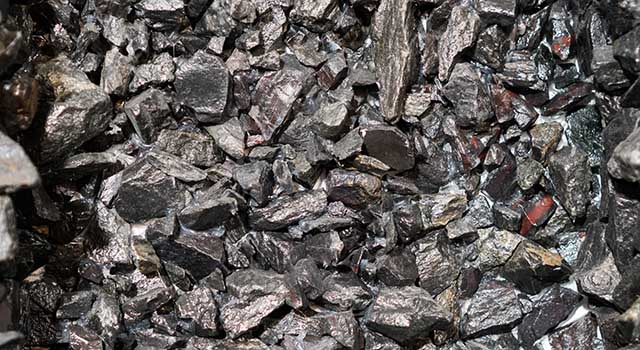 Close up view of the iron ore. rough Hematite, iron Kidney Ore stone. Pieces of ferrotitanium closeup. Close-up view of the iron stone.