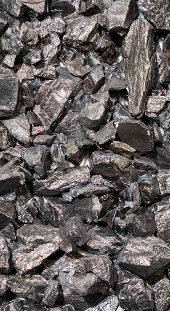 Close up view of the iron ore. rough Hematite, iron Kidney Ore stone. Pieces of ferrotitanium closeup. Close-up view of the iron stone.