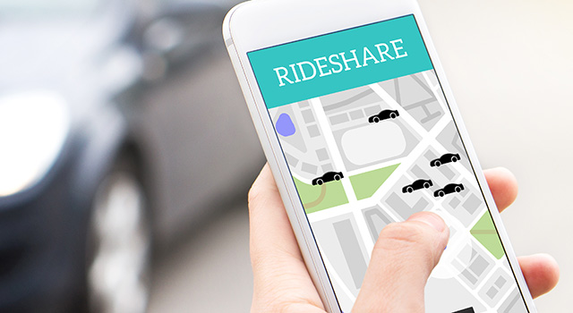 Ride share taxi service on smartphone screen. Online rideshare app and carpool mobile application. Woman holding phone with a car in the background. Person ordering ride with cellphone.