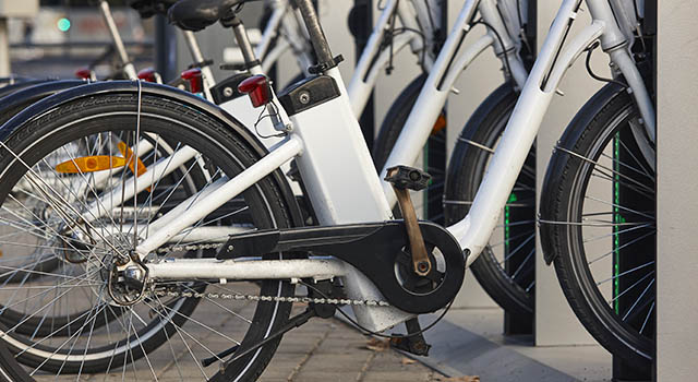 Urban electric bikes charging batteries in the city. For rent