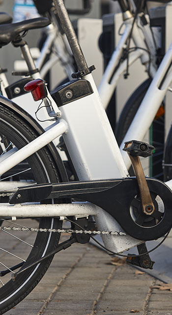 Urban electric bikes charging batteries in the city. For rent