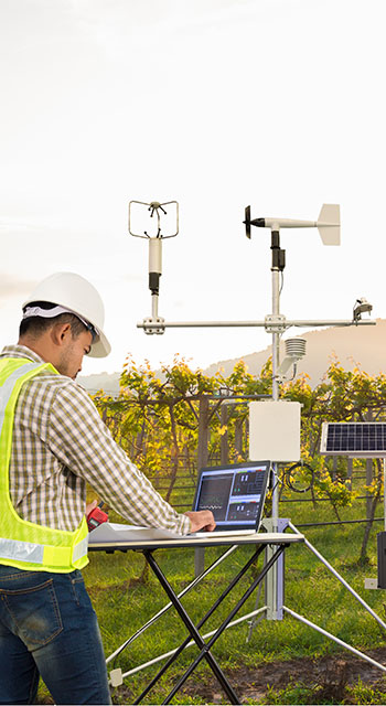 Agronomist using tablet computer collect data with meteorological instrument to measure the wind speed, temperature and humidity and solar cell system in grape agricultural field, Smart farm concept