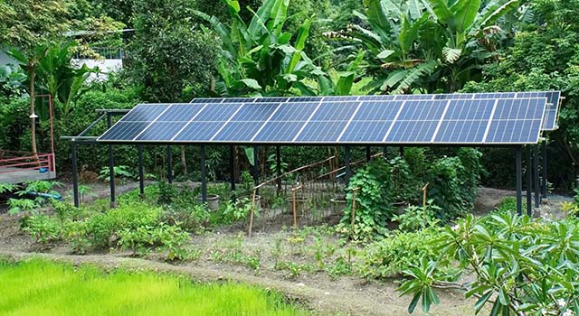 Solar cell roof in the garden background. Long solar panel roof for agriculture in the garden.