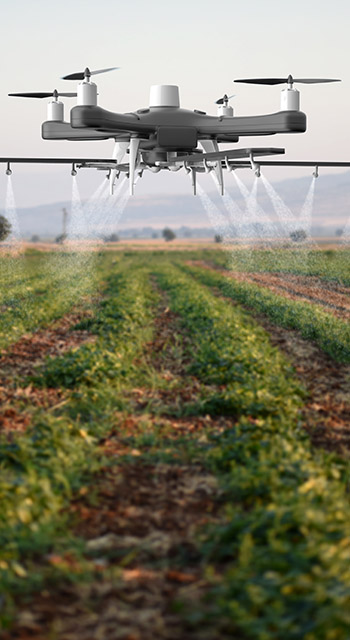 Drone spraying a field