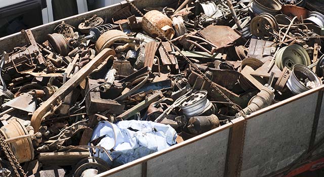 Assorted car and other scrap metal items in a large trailer.