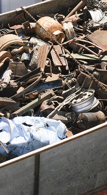 Assorted car and other scrap metal items in a large trailer.