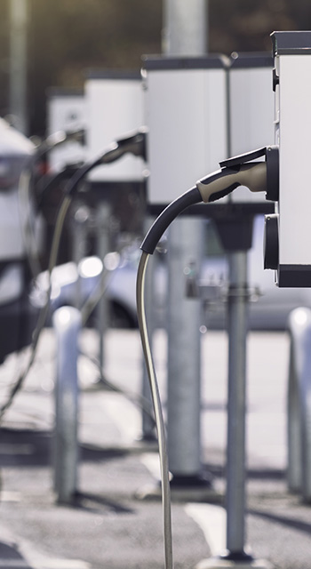 A parking lot with charging stations for electric cars.