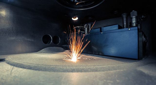 3D printer printing metal. Laser sintering machine for metal. Metal is sintered under the action of laser into shape. DMLS, SLM, SLS. Modern additive technologies 4.0 industrial revolution. Sparks