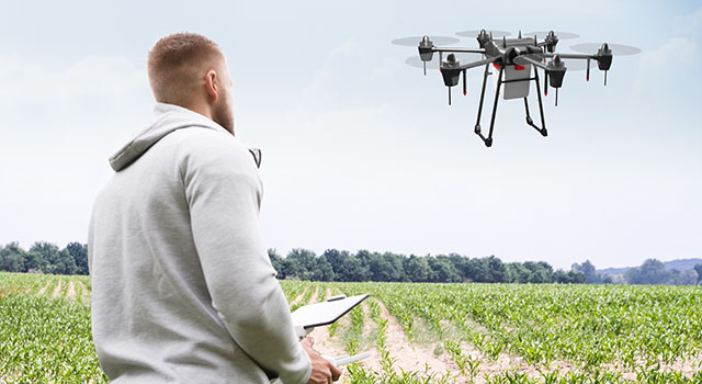 Man Operating The Quadrocopter In The Park