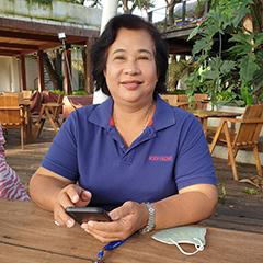 Somchit Kaeokhun, a farmer producing “Nakhon Nayok Giant Marian Plum” is sitting at a wooden table